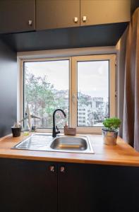 a kitchen counter with a sink and a window at Cihangir, Taksim, İstanbul Bosphorus View in Istanbul