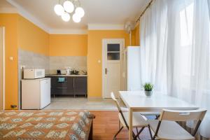 kuchnia i jadalnia ze stołem i krzesłami w obiekcie BpR Cercle Point Apartment w Budapeszcie
