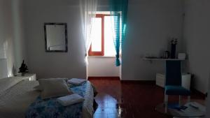 a small bedroom with a bed and a window at Emidio House in Termini