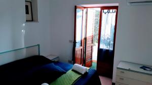a bedroom with a bed and a sliding glass door at Emidio House in Termini