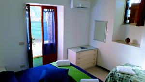 a bedroom with a bed and a dresser and a window at Emidio House in Termini