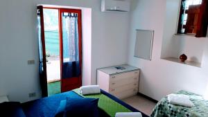 a bedroom with a bed and a door to the ocean at Emidio House in Termini