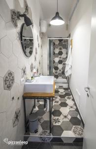 a bathroom with a sink and a mirror at PizzaSleep B&B in Naples