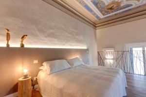 Llit o llits en una habitació de Mamo Florence - Freedom Apartments