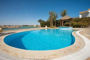 duży niebieski basen z altaną w obiekcie Sunset Villa in El Gouna with Private Heated Pool w mieście Hurghada