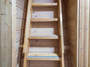 a wooden closet with stairs in it at Holiday Home Lähikaltio 314 by Interhome in Äkäslompolo +7 photos
