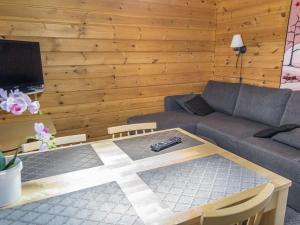 a living room with a couch and a coffee table at Holiday Home Lähikaltio 314 by Interhome in Äkäslompolo