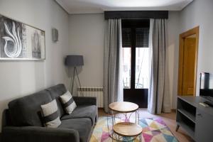 a living room with a couch and a tv at Hotel Las Moradas in Ávila