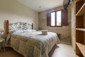 Postel nebo postele na pokoji v ubytování Gran Casa Rural A Touza
