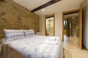 Postel nebo postele na pokoji v ubytování Gran Casa Rural A Touza