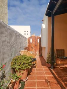 a balcony with potted plants and a fence at Paradise Villa in Corralejo
