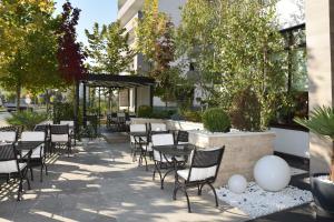 a patio with tables and chairs in a building at Hotel Bulevard in Râmnicu Vâlcea