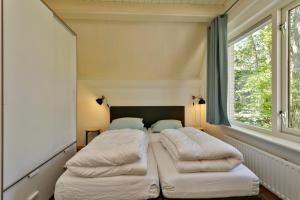 Postel nebo postele na pokoji v ubytování Vakantiehuis Eekhoorn Nunspeet Veluwe