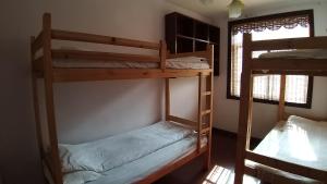a room with two bunk beds and a window at Makerhouse Hostel in Hefei