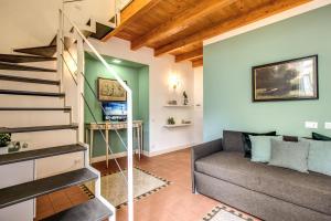 a living room with a staircase and a couch at Casa Hosteno in Naples