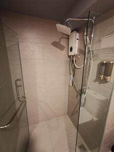 a shower in a bathroom with a glass door at EkoCheras Balcony City View King Bed Rooftop Pool High Speed Fibre Internet MRT Connection in Kuala Lumpur