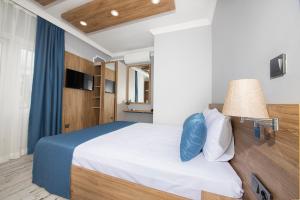 A bed or beds in a room at Marina Hotel Bodrum