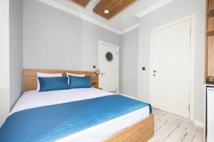 A bed or beds in a room at Marina Hotel Bodrum