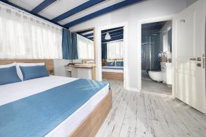 A bed or beds in a room at Marina Hotel Bodrum