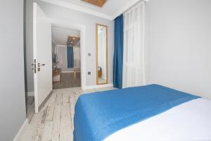 A bed or beds in a room at Marina Hotel Bodrum