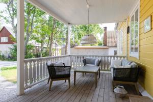 a porch with two chairs and a table at Strandvillan Ljugarn in Ljugarn