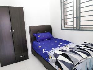 a small bedroom with a bed and a cabinet at Lake Residence 167 aesthetic lakeview best photograph in Putrajaya