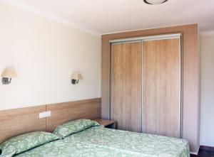 A bed or beds in a room at Apartamentos Maspalomas Foresta