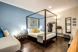 A bed or beds in a room at Casa Hosteno