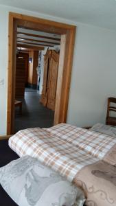 a bedroom with two beds and a hallway at Chalet Bärgblick in Grindelwald