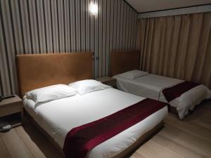 Postel nebo postele na pokoji v ubytování Igiban Hotel