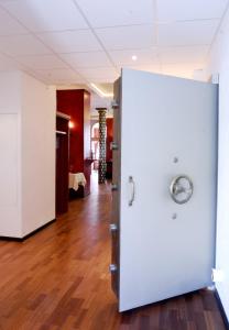 a white refrigerator in a room with a wooden floor at Alte Reichsbank in Schweinfurt