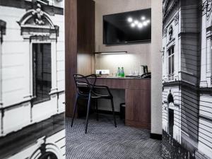 a room with a desk with a chair in a building at Hotel Logos Kraków in Krakow