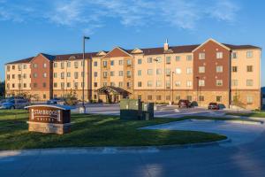 a large building with a sign in front of it at Staybridge Suites Omaha West, an IHG Hotel in Omaha