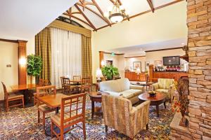 a living room with furniture and a stone wall at Staybridge Suites-Knoxville Oak Ridge by IHG in Oak Ridge