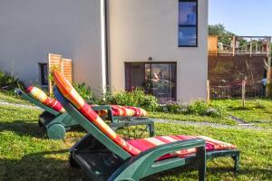 a group of chairs in the grass in front of a house at le Pic vert in Surzur