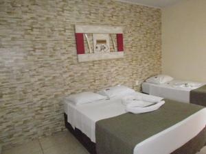 מיטה או מיטות בחדר ב-Pousada Quinta Das Aroeiras