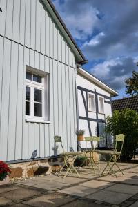 a group of chairs sitting outside of a house at Ferienwohnung im Fachwerkhof 'Haus in Bewegung' in Seelscheid