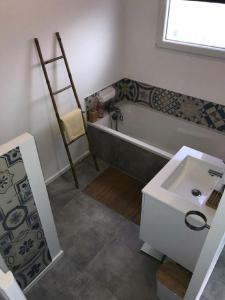 a bathroom with a bath tub and a sink at jardin zen in La Londe-les-Maures