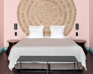 a bedroom with a large bed with two tables at New Hotel Le Quai - Vieux Port in Marseille