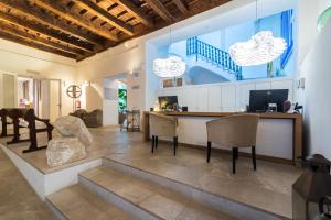 a living room with a counter and chairs in a room at ICON Rosetó in Palma de Mallorca