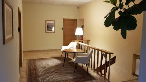 a hallway with a table and chairs and a stairway at Nėris Inn Terraces in Vilnius