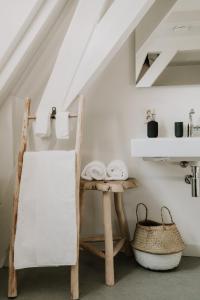 a white room with a table and a chair at Brass Hotel in Utrecht