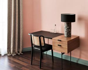 a desk with a chair and a lamp and a dresser at New Hotel Le Quai - Vieux Port in Marseille