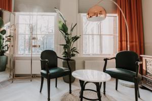 a living room filled with furniture and a window at Brass in Utrecht