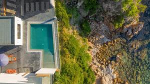 an overhead view of a swimming pool on the side of a cliff at Hotel le Jardin d'Emile in Porticcio