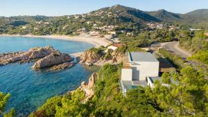 an aerial view of a beach with a house at Hotel le Jardin d'Emile in Porticcio