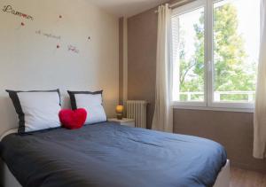 a bedroom with a blue bed with a red heart on it at SWEETHOME DIJON - Gare in Dijon