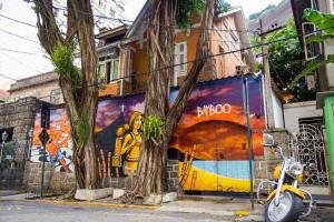 a street scene with graffiti on the side of a building at Bamboo Rio Hostel in Rio de Janeiro