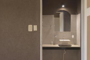 a bathroom with a sink and a mirror at Apart Hotel La Bodega in San Rafael