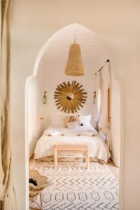 a bedroom with a bed with a large mirror at Riad Le Pèlerin in Marrakesh